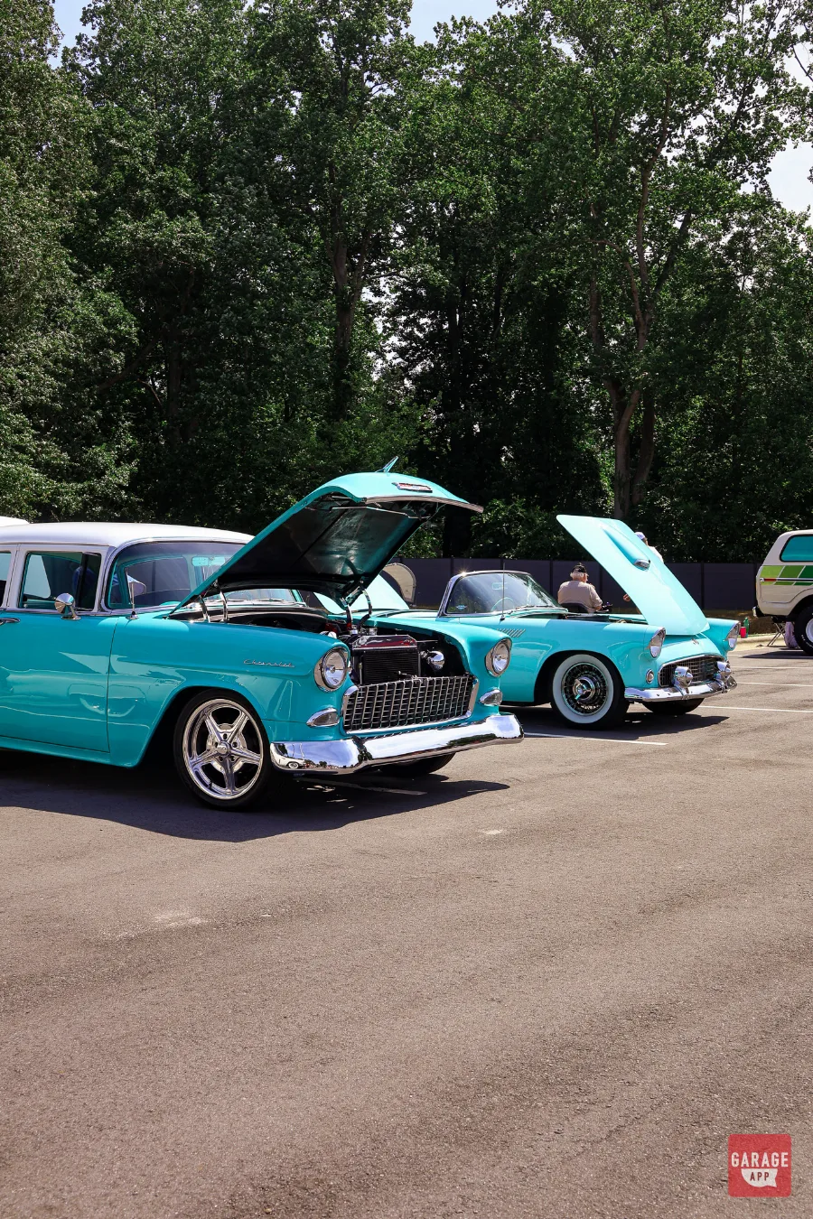 Restored 1955 Chevrolet Bel Air and 1955 Ford Thunderbird displayed with their hoods open at Fuquay-Varina Cars and Coffee in North Carolina.