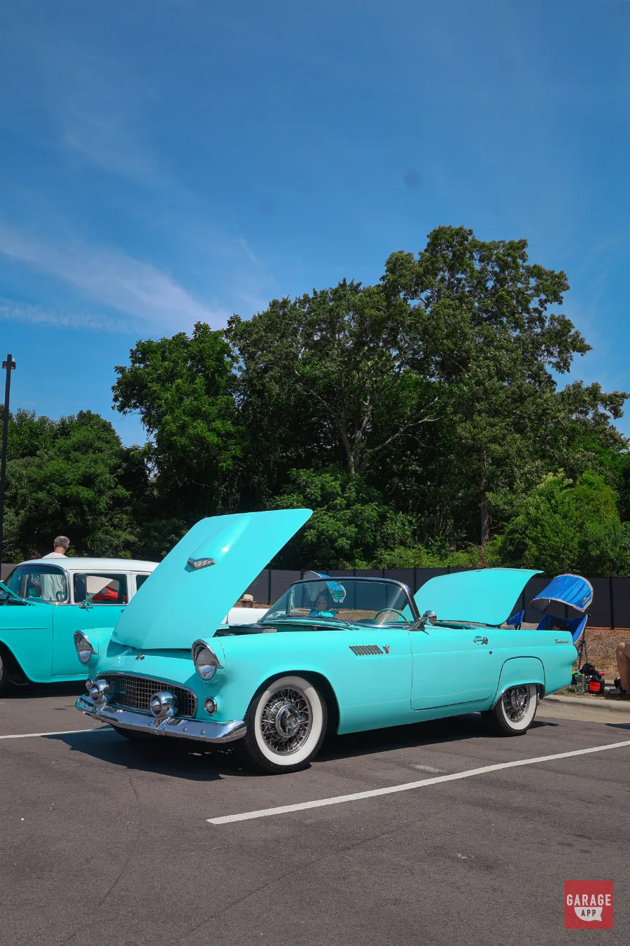 Turquoise 1955 Ford Thunderbird convertible with whitewall tires showcased at Fuquay-Varina Cars and Coffee in North Carolina.