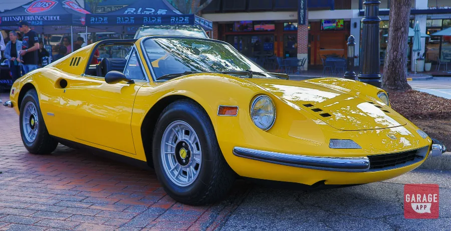 Ferrari Dino 246 GT in Giallo Fly yellow parked outdoors, highlighting one of the most beautiful classic Ferraris ever produced.