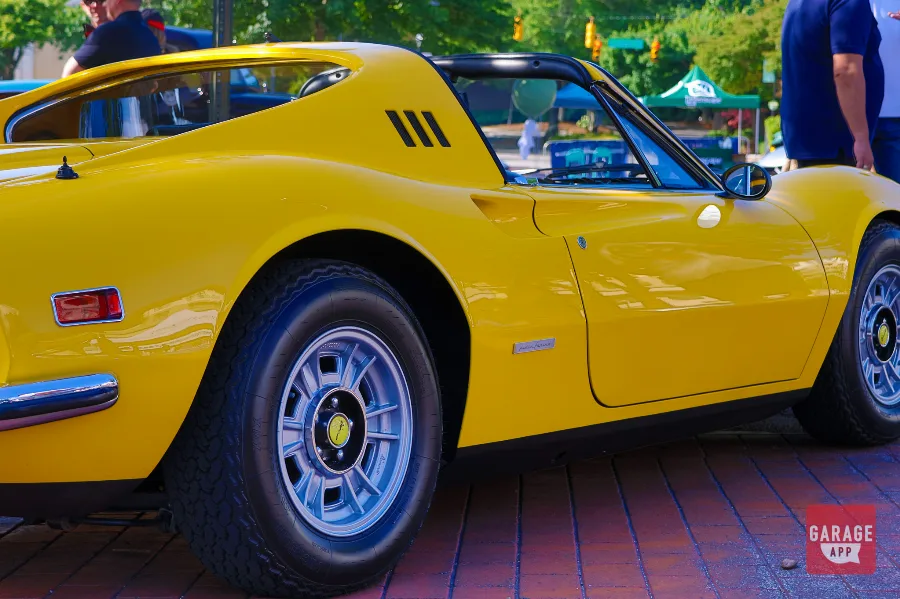 Front three-quarter view of a Ferrari Dino 246 GT finished in Giallo Fly yellow, showcasing timeless Pininfarina styling and classic Ferrari design.
