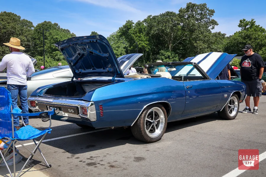 Rear three-quarter view of a restored 1970 Chevrolet Chevelle SS 454 Convertible with trunk open at a classic car event.
