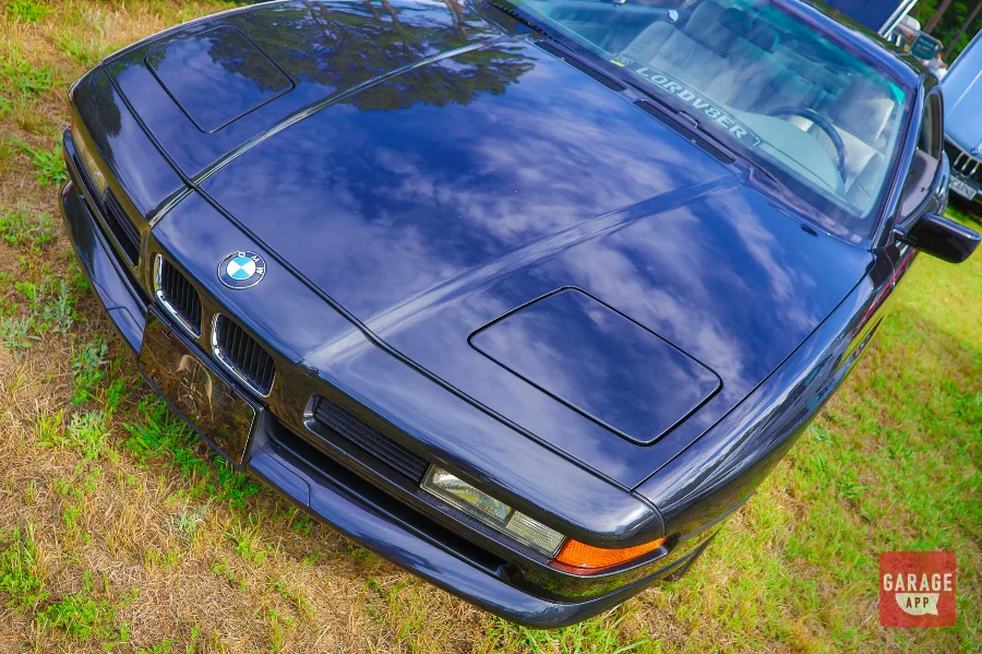 Detail photo of the hood and closed pop-up headlights on a black 1995 BMW 840Ci E31 luxury coupe.