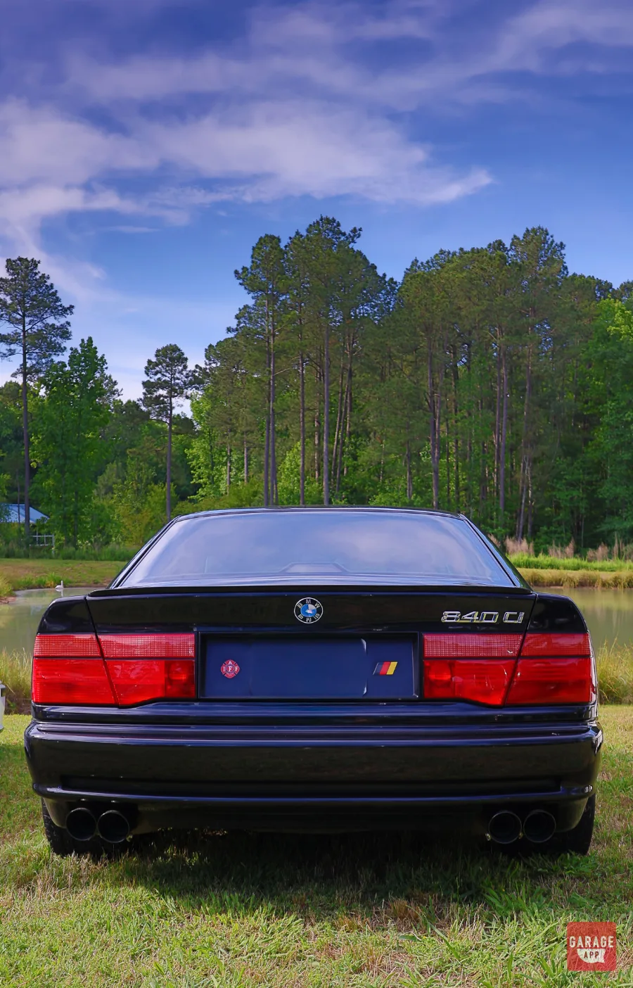 Rear view of a black 1995 BMW 840Ci E31 featuring the full-width taillights, 840Ci badging, and quad exhaust tips.