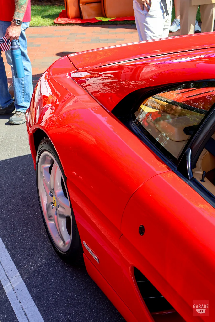 Rear quarter view of a red Ferrari F355 highlighting the Pininfarina body design.