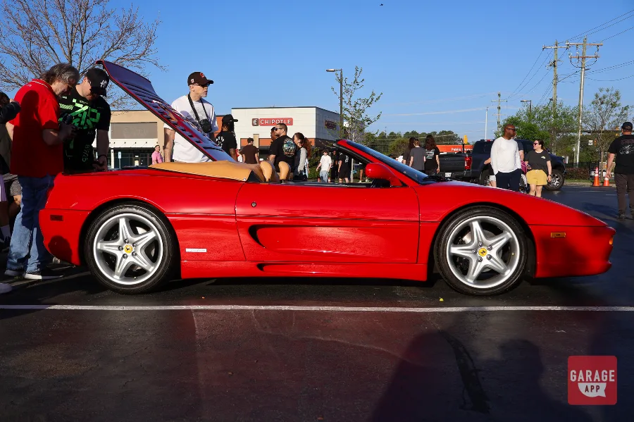 Full side profile of a Ferrari F355 Spider convertible with the top down.