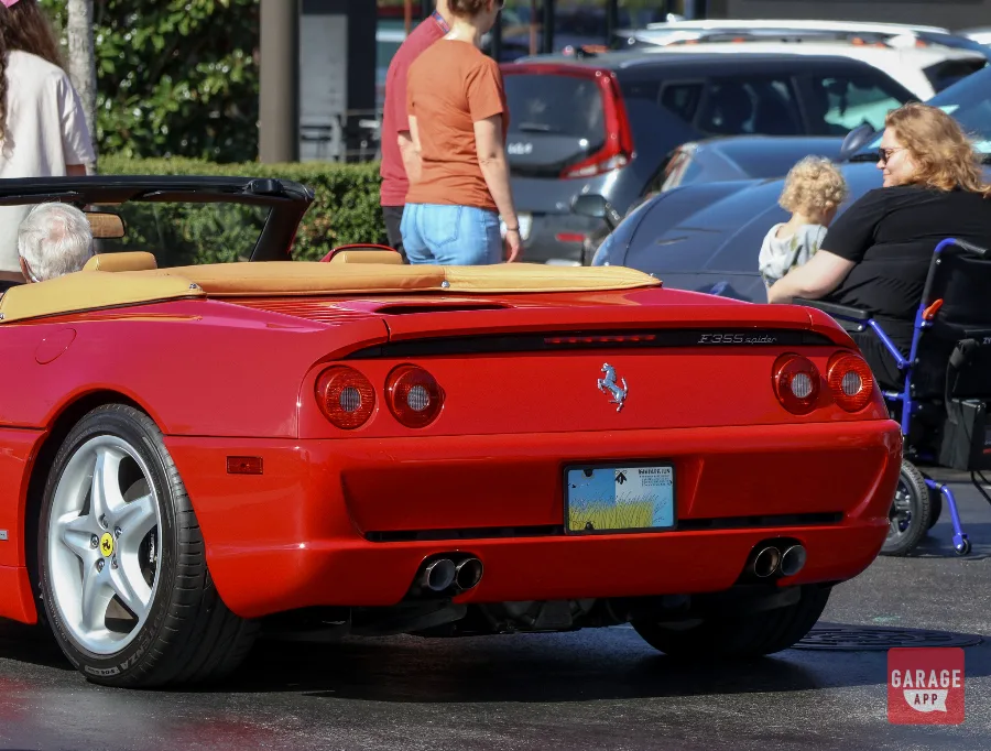 Rear view of a Ferrari F355 Spider showing quad exhaust tips and classic Ferrari styling.
