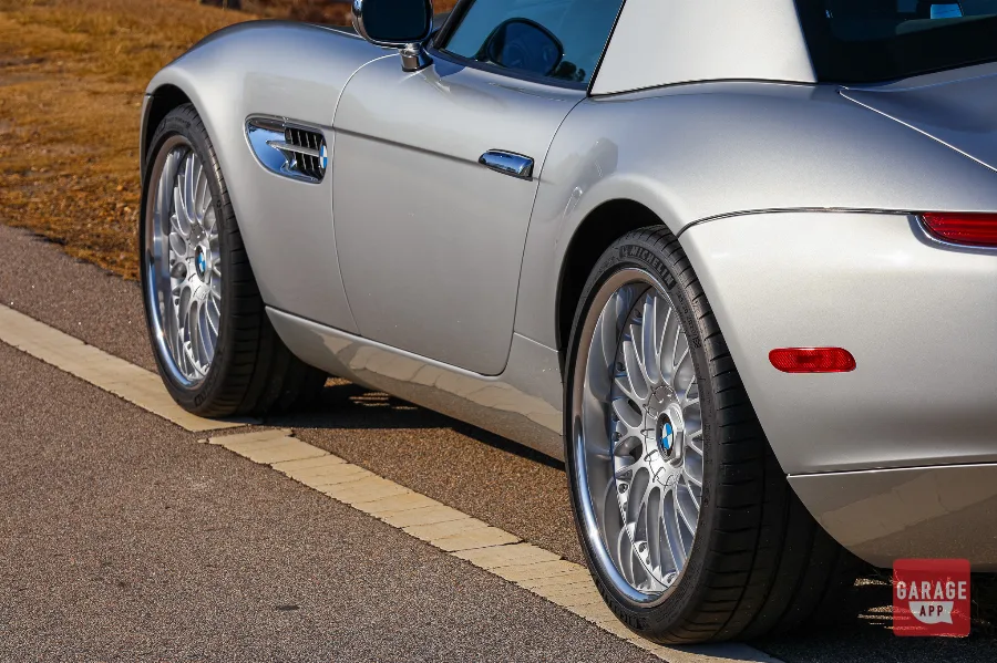 Driver-side view of a 2001 BMW Z8 in Titanium Silver Metallic, highlighting its long hood and short rear deck proportions.