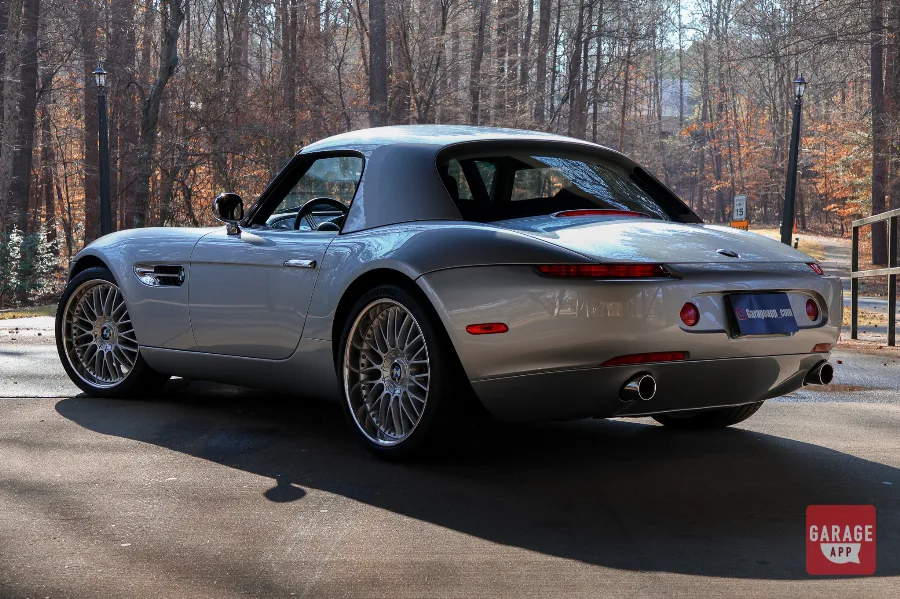 Rear three-quarter view of a 2001 BMW Z8 in Titanium Silver Metallic, showcasing the elegant rear fenders, dual exhaust outlets, and classic BMW roadster styling.