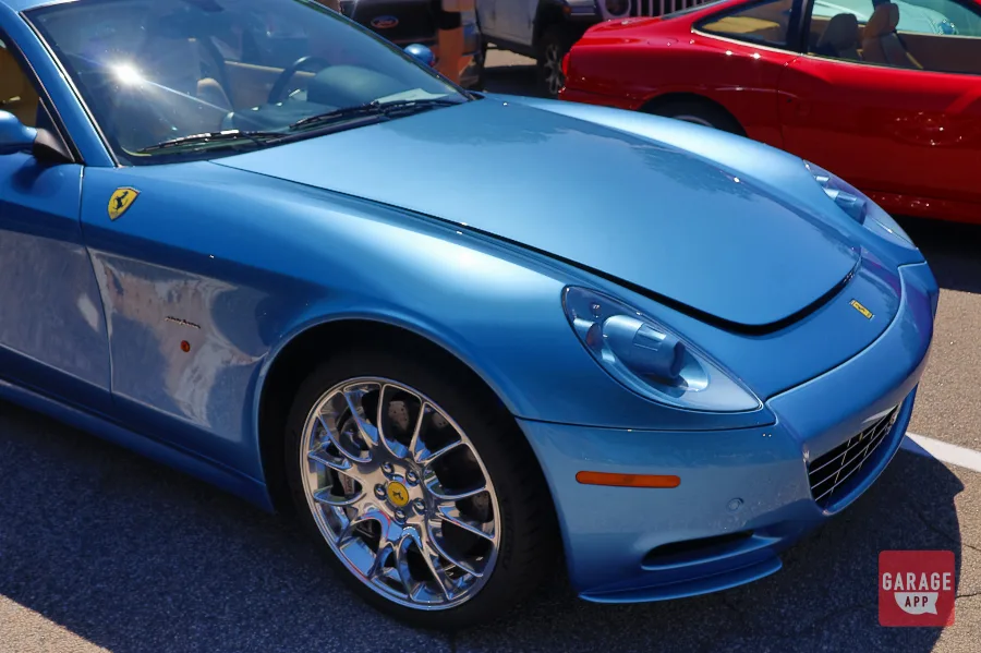 Front fender and headlight detail of a Ferrari 612 Scaglietti showing Pininfarina styling and Azzurro California paintwork