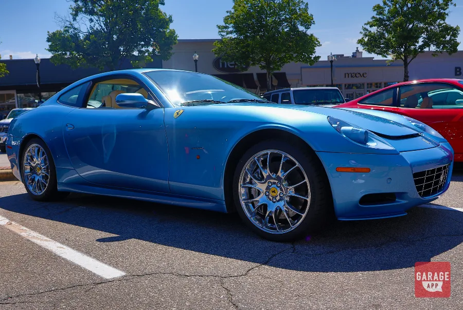 Low-angle side profile of a 2008 Ferrari 612 Scaglietti showcasing its long-wheelbase grand touring design and polished alloy wheels