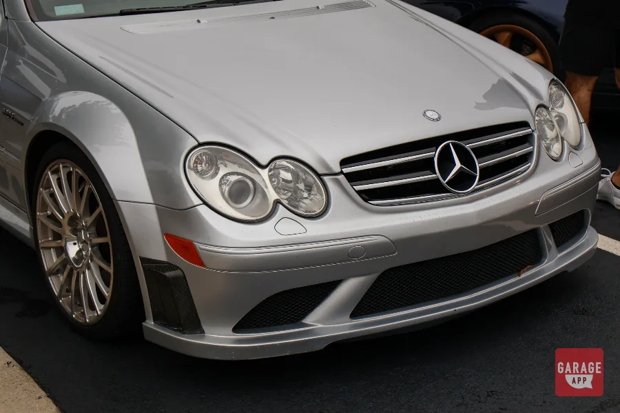 Front view of a 2009 Mercedes-Benz CLK 63 AMG Black Series in Iridium Silver Metallic, showcasing the sculpted hood, AMG grille, and naturally aspirated performance coupe styling.