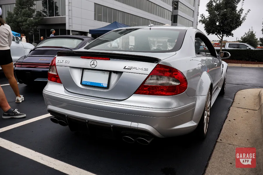 Rear view of a 2009 Mercedes-Benz CLK 63 AMG Black Series finished in Iridium Silver Metallic, highlighting AMG badging, quad exhaust tips, and the carbon fiber rear spoiler.
