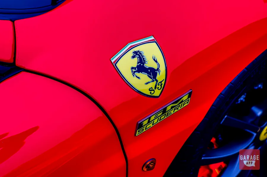 Ferrari F430 Scuderia Spider 16M fender badge and Ferrari shield on Rosso Corsa bodywork highlighting the limited-production performance model.