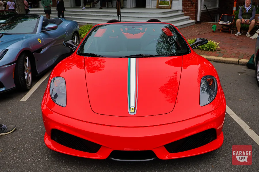 2009 Ferrari F430 Scuderia Spider 16M displayed with informational placard during a collector car event and automotive showcase.
