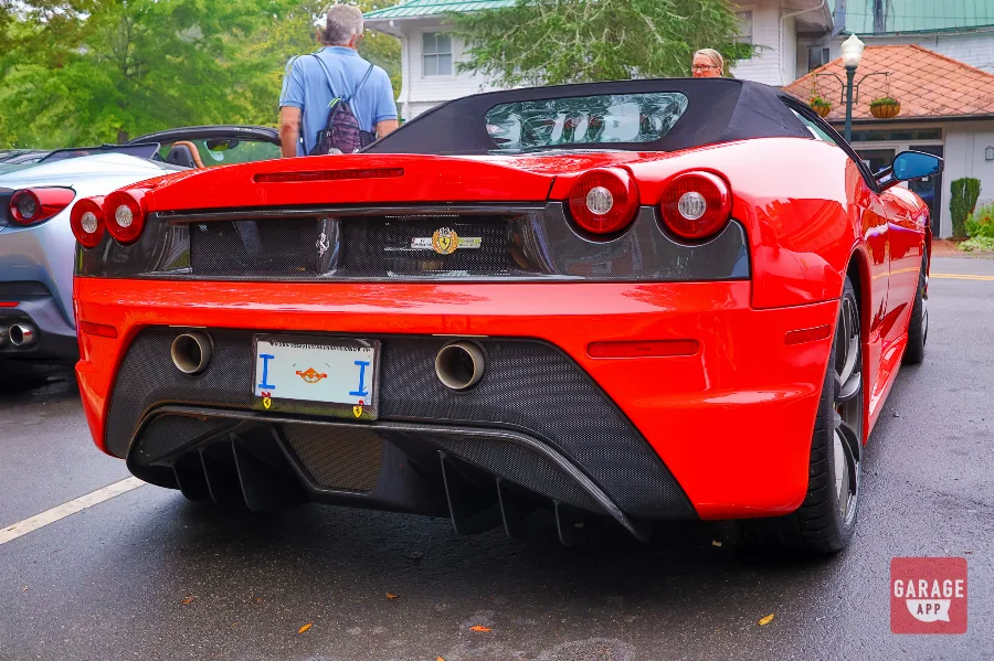 Rear view of the 2009 Ferrari F430 Scuderia Spider 16M highlighting the carbon fiber diffuser, twin exhaust outlets, and commemorative 16M badge.