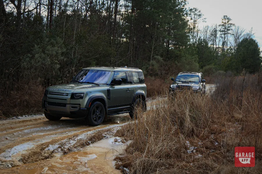 Land Rover Defender 90 followed by a Toyota 4Runner on muddy forest roads during an overlanding adventure.