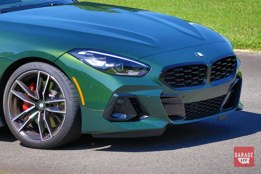 Front corner detail of a BMW Z4 M40i manual in San Remo Green, emphasizing the sculpted bumper and LED headlights.