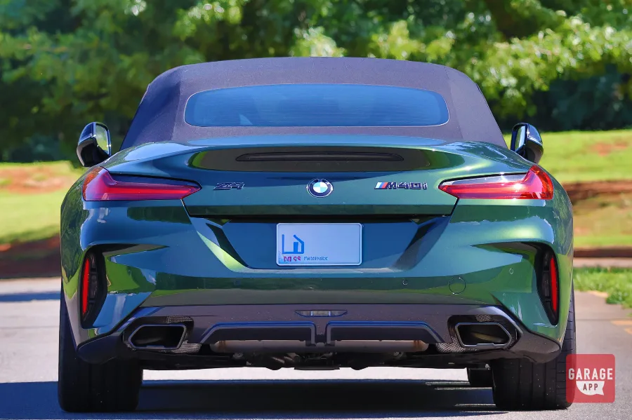 Rear view of a BMW Z4 M40i manual finished in San Remo Green, showcasing dual exhaust outlets and sporty rear styling.