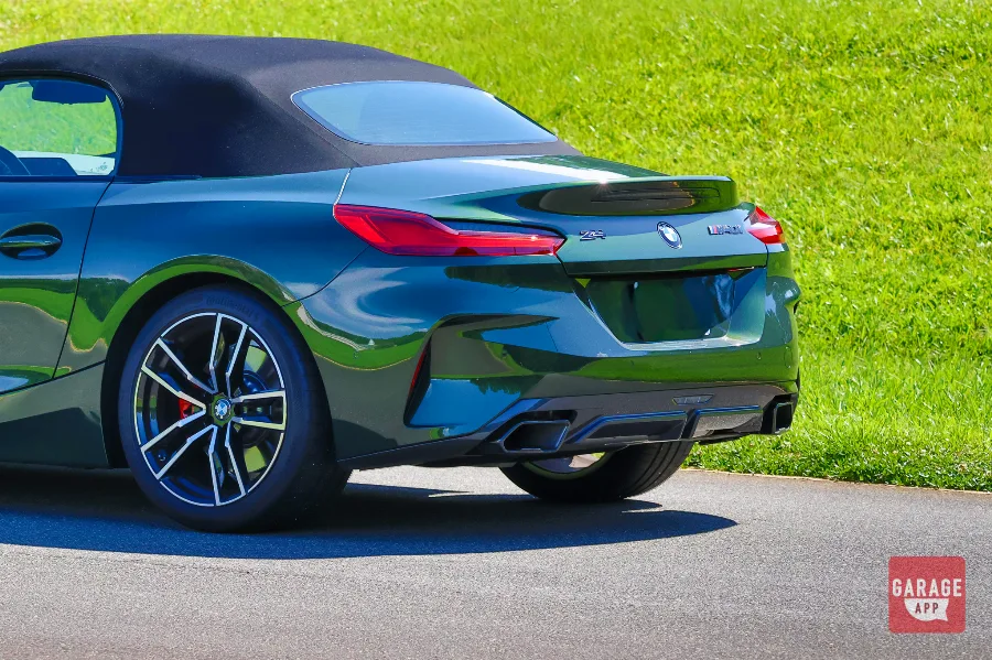 Low-angle shot of a BMW Z4 M40i manual in San Remo Green, emphasizing its wide stance and performance-focused appearance.