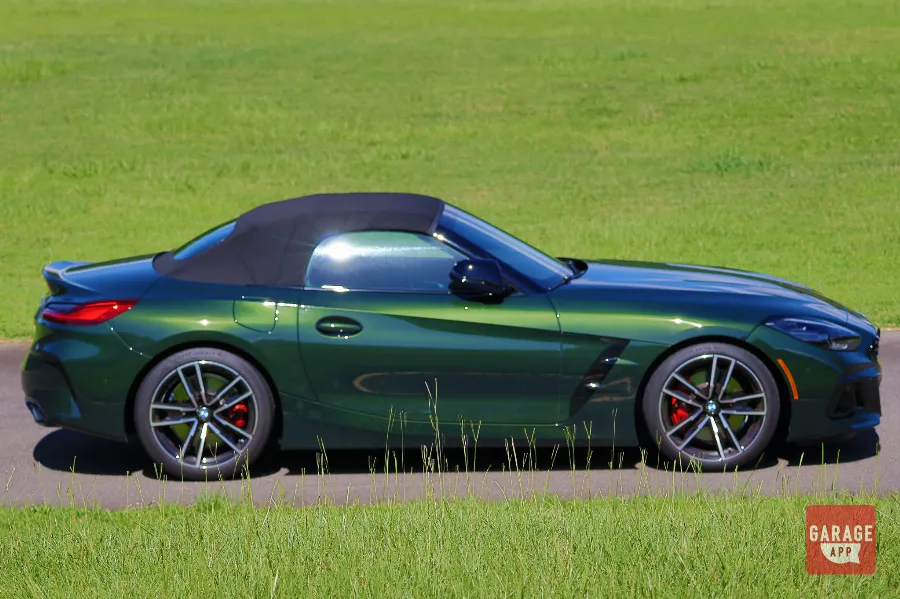 Side profile of a BMW Z4 M40i manual in San Remo Green, highlighting the sleek convertible silhouette and long hood design.