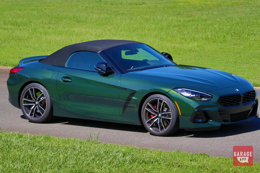 Front three-quarter view of a BMW Z4 M40i manual finished in San Remo Green, showcasing the roadster's aggressive styling and rear-wheel-drive proportions.