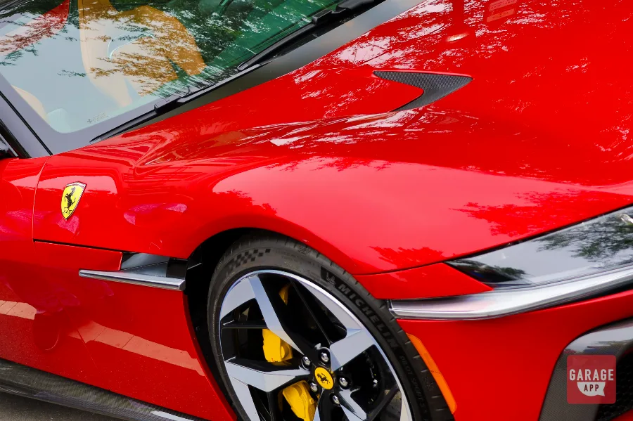 Rear design view of a 2025 Ferrari 12Cilindri Spider in Rosso Corsa featuring quad exhaust outlets and distinctive Ferrari V12 styling.