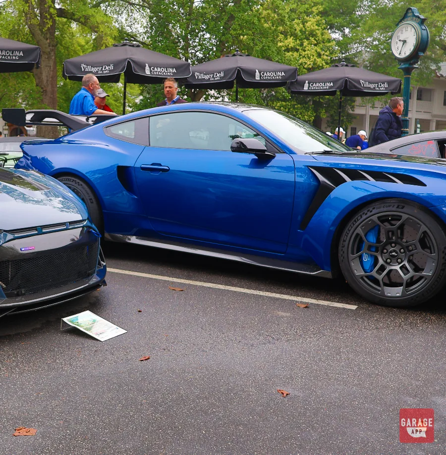 Blue 2025 Ford Mustang GTD driver side profile displayed at a Cars and Coffee event, featuring aggressive aerodynamics, carbon fiber bodywork, and track-focused styling.