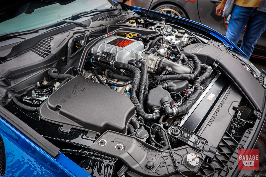 Wide view of the supercharged V8 engine bay in a 2025 Ford Mustang GTD, featuring carbon fiber bracing, advanced cooling systems, and Ford Performance engineering.