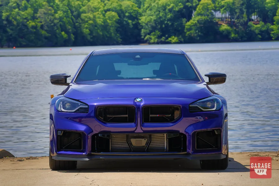Front view of a 2026 BMW M2 CS in Velvet Blue showing the redesigned front fascia and signature BMW kidney grilles.