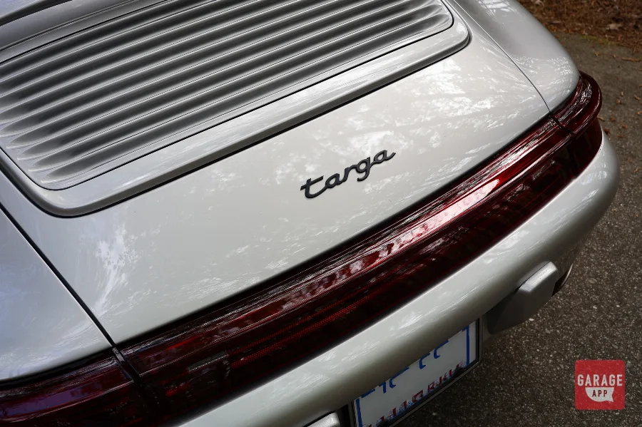 Close-up of the Porsche 993 Targa rear badging, showcasing the iconic Targa lettering and classic air-cooled Porsche 911 design details.