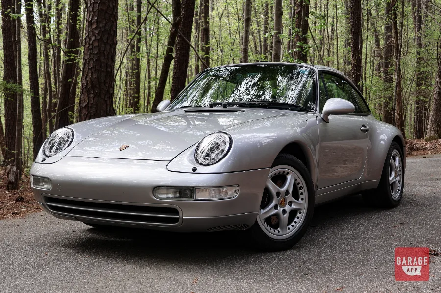 Front three-quarter view of a Porsche 993 Targa showcasing the iconic air-cooled Porsche 911 design.