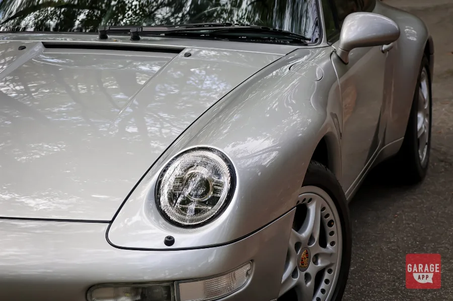 Porsche 993 Targa parked roadside, representing one of the most sought-after air-cooled Porsche models.