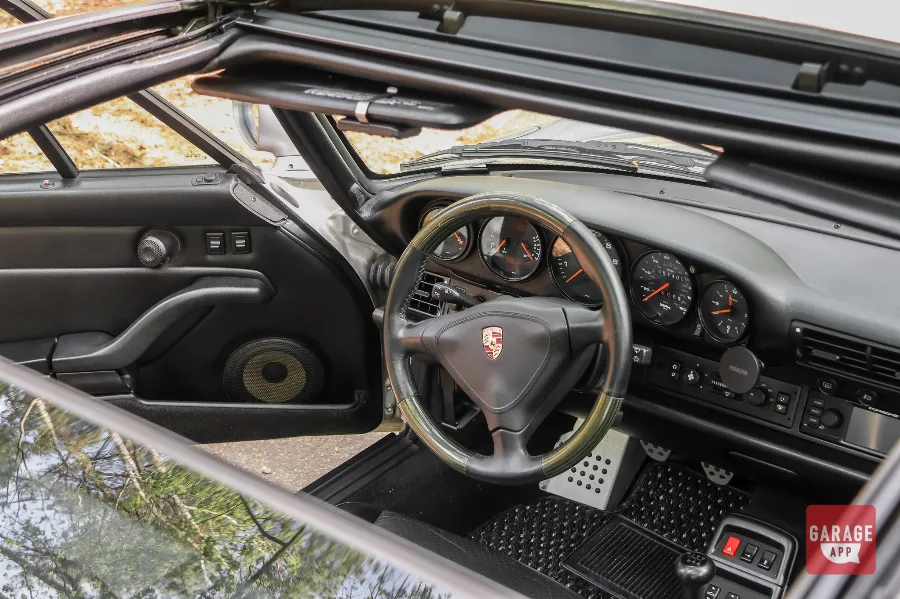 Porsche 993 Targa with glass roof open, highlighting the open-air driving experience.