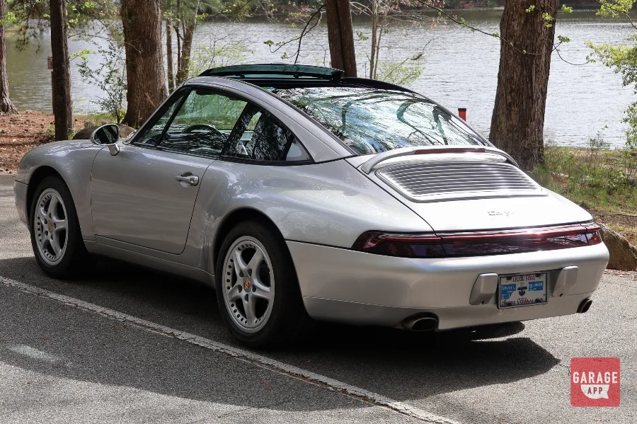 Rear three-quarter photograph of a Porsche 993 Targa featuring wide rear fenders and classic air-cooled styling.