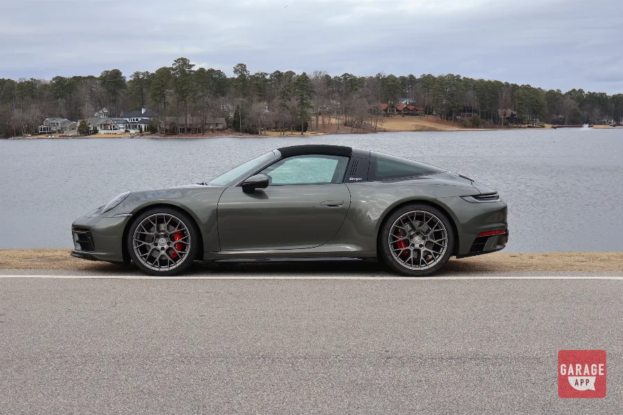 Aventurine Green Porsche 911 Targa4s side profile parked by lake