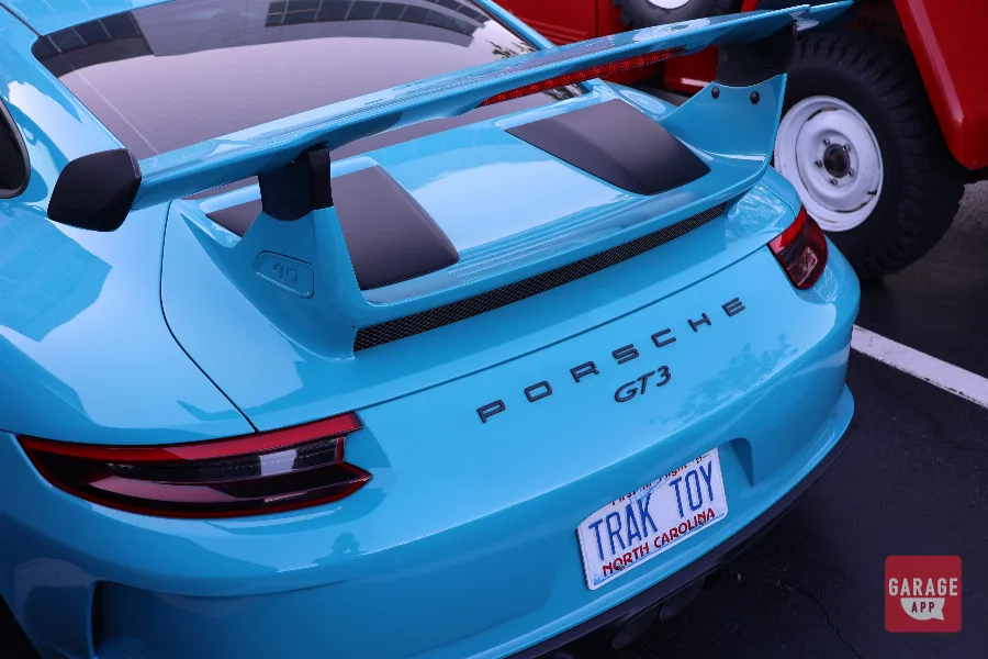 Porsche 911 GT3 rear wing and badge close-up light blue