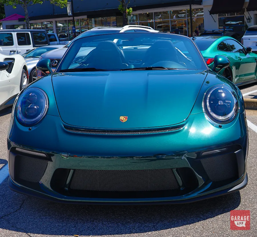 Head-on view of a green Porsche 911 Speedster highlighting its distinctive front fascia and wide track.
