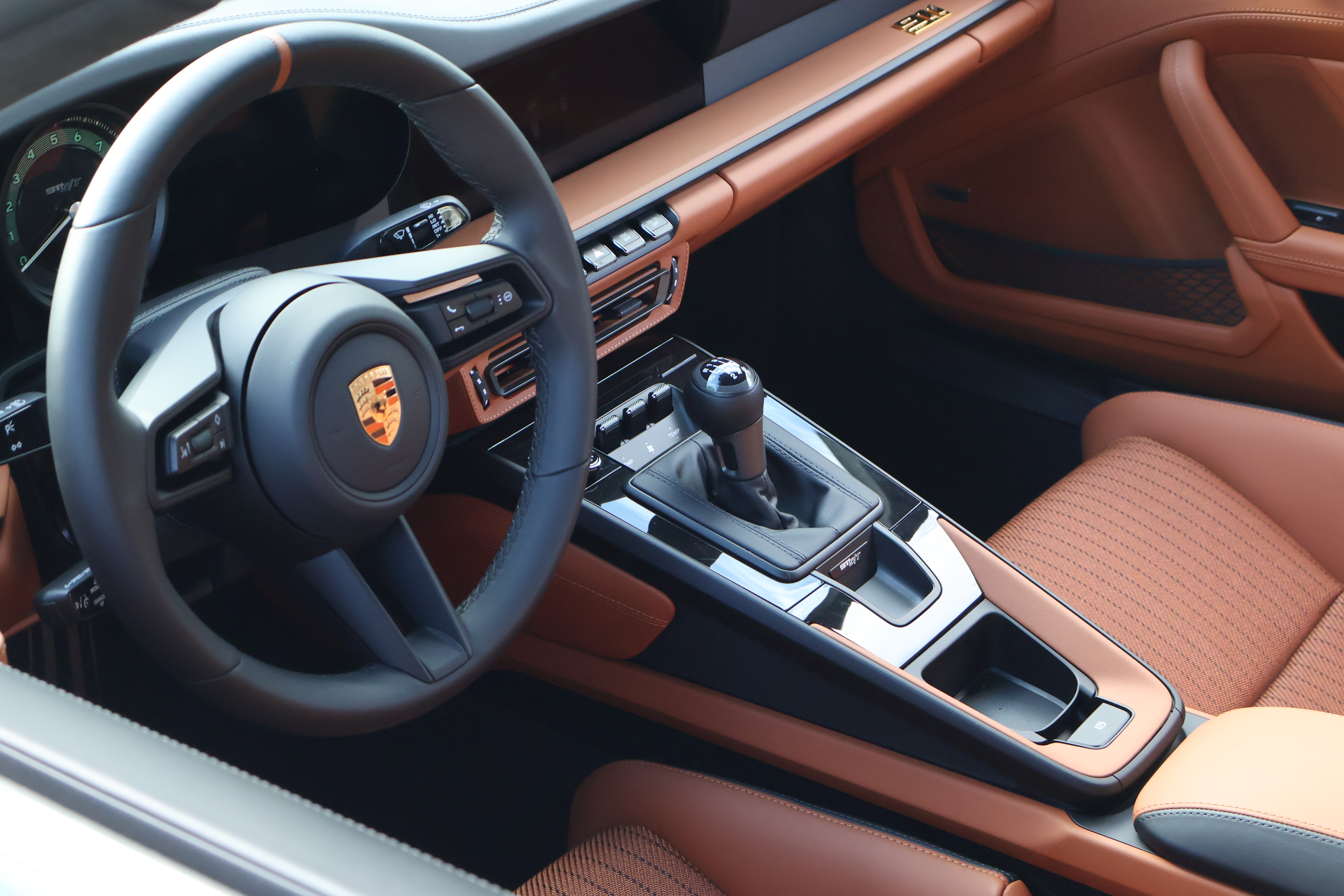 Porsche 911 S/T interior featuring manual transmission, driver-focused cockpit, and premium materials designed for enthusiast driving.
