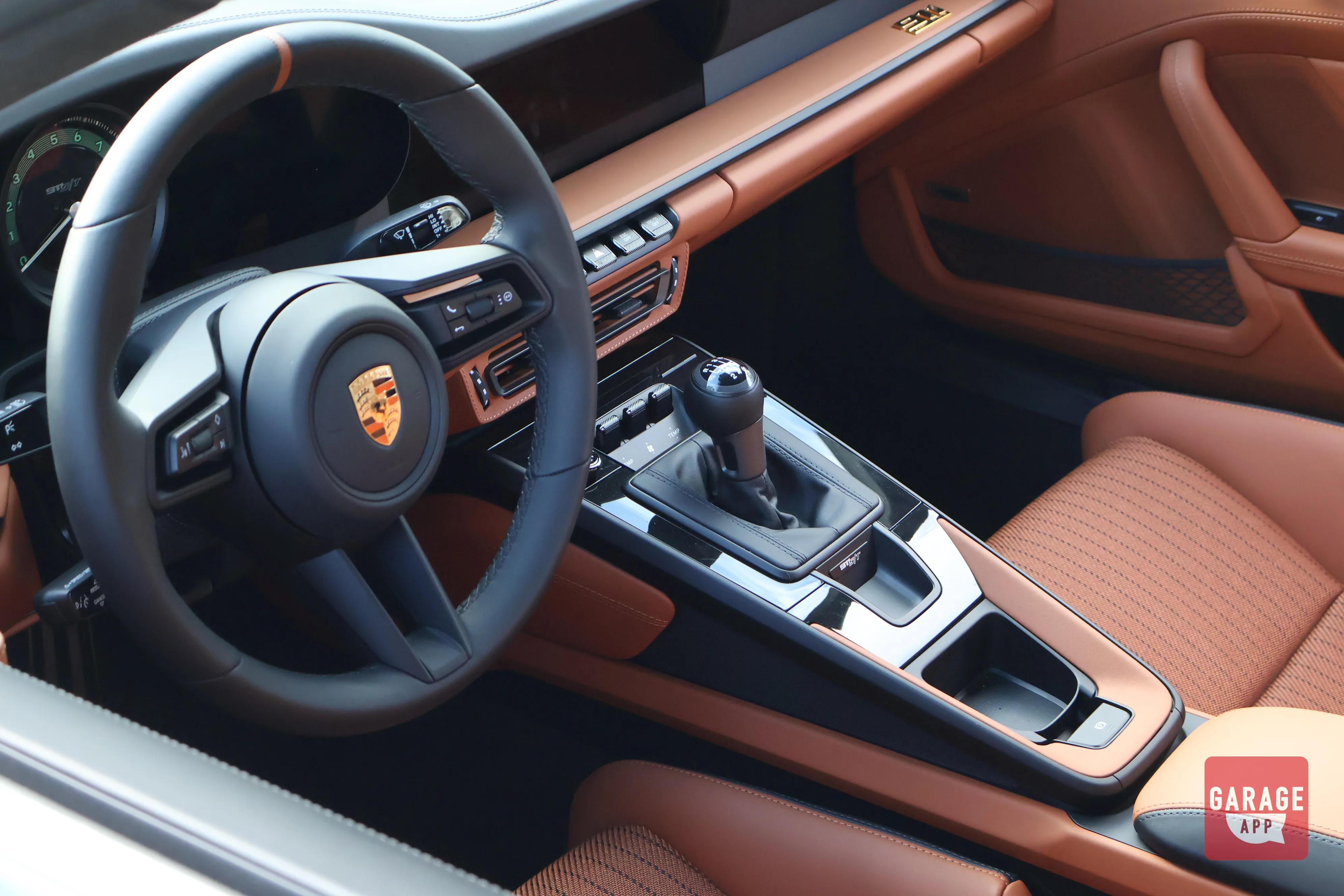 Porsche 911 S/T interior featuring manual transmission, driver-focused cockpit, and premium materials designed for enthusiast driving.