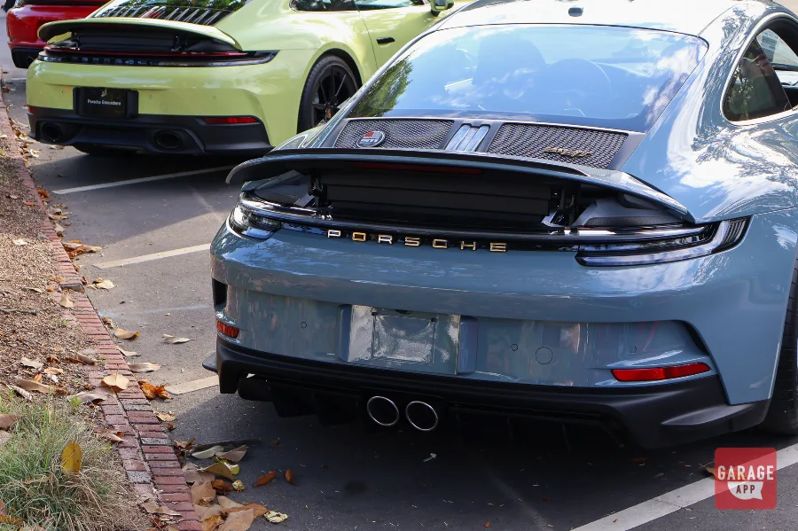 Rear view of a 2024 Porsche 911 S/T finished in Shore Blue Metallic, showcasing the clean rear design and limited-production sports car styling.