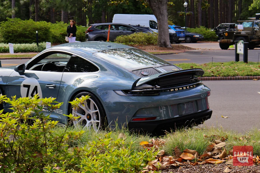 Rear three-quarter photograph of a 2024 Porsche 911 S/T finished in Shore Blue Metallic, featuring the Heritage Design Package and classic Porsche proportions.