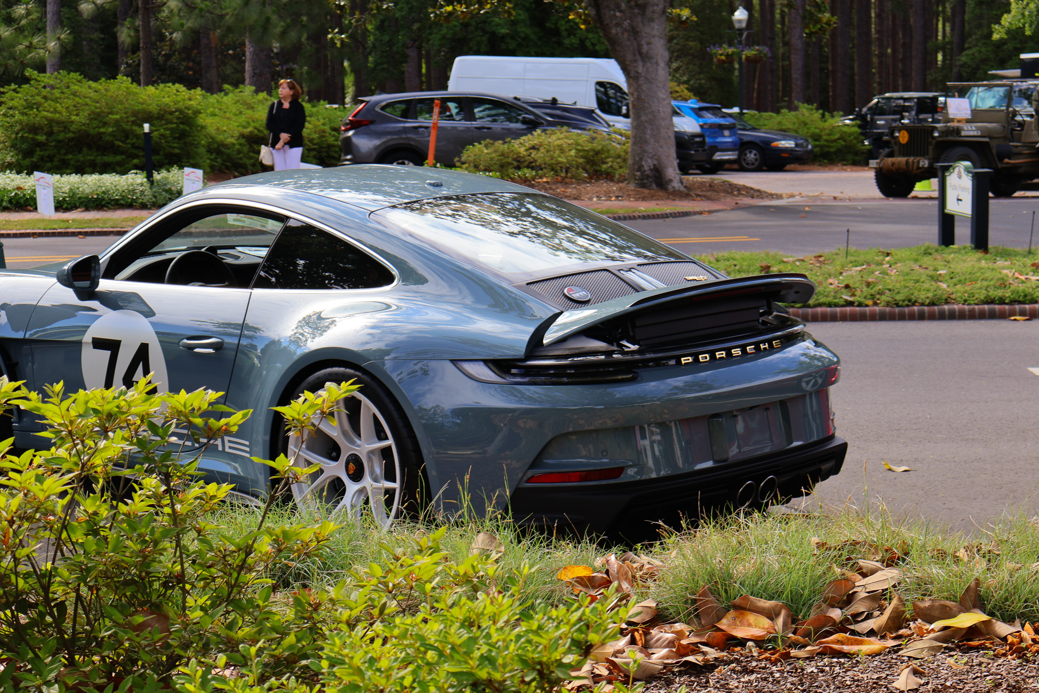 Rear three-quarter photograph of a 2024 Porsche 911 S/T finished in Shore Blue Metallic, featuring the Heritage Design Package and classic Porsche proportions.