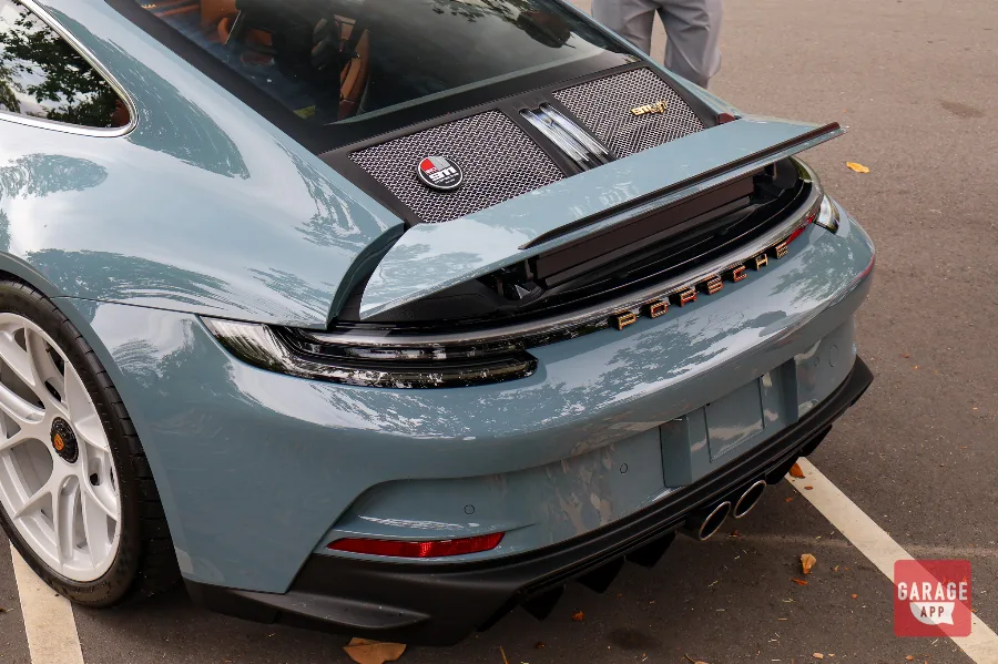 Close-up of the body lines on a 2024 Porsche 911 S/T finished in Shore Blue Metallic, showcasing timeless Porsche craftsmanship.