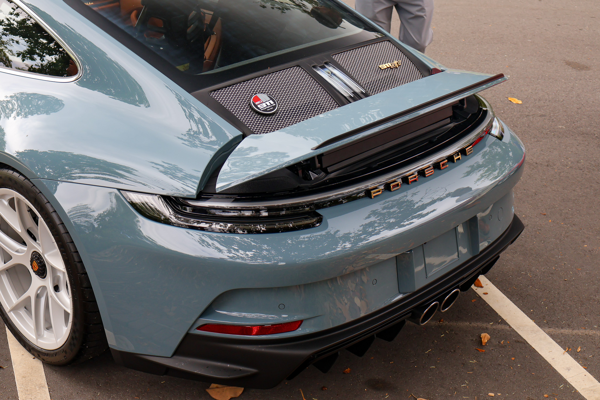Close-up of the body lines on a 2024 Porsche 911 S/T finished in Shore Blue Metallic, showcasing timeless Porsche craftsmanship.