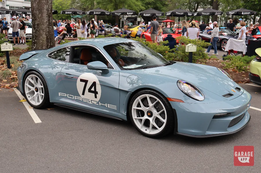 Side profile of a 2024 Porsche 911 S/T in Shore Blue Metallic, highlighting the six-speed manual sports car and iconic 911 silhouette.