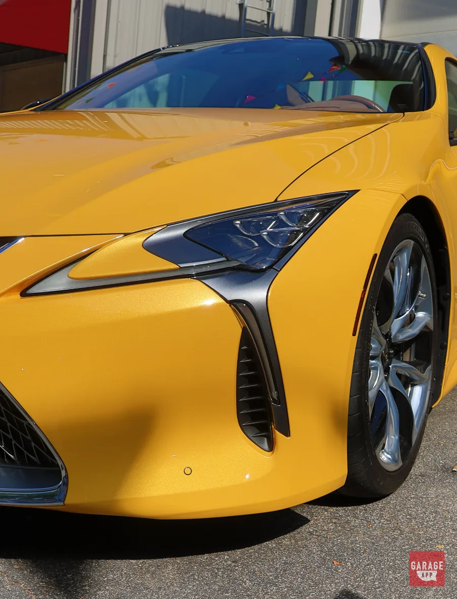 Close-up of the Lexus LC 500 front fascia featuring LED headlights and signature Lexus design elements.