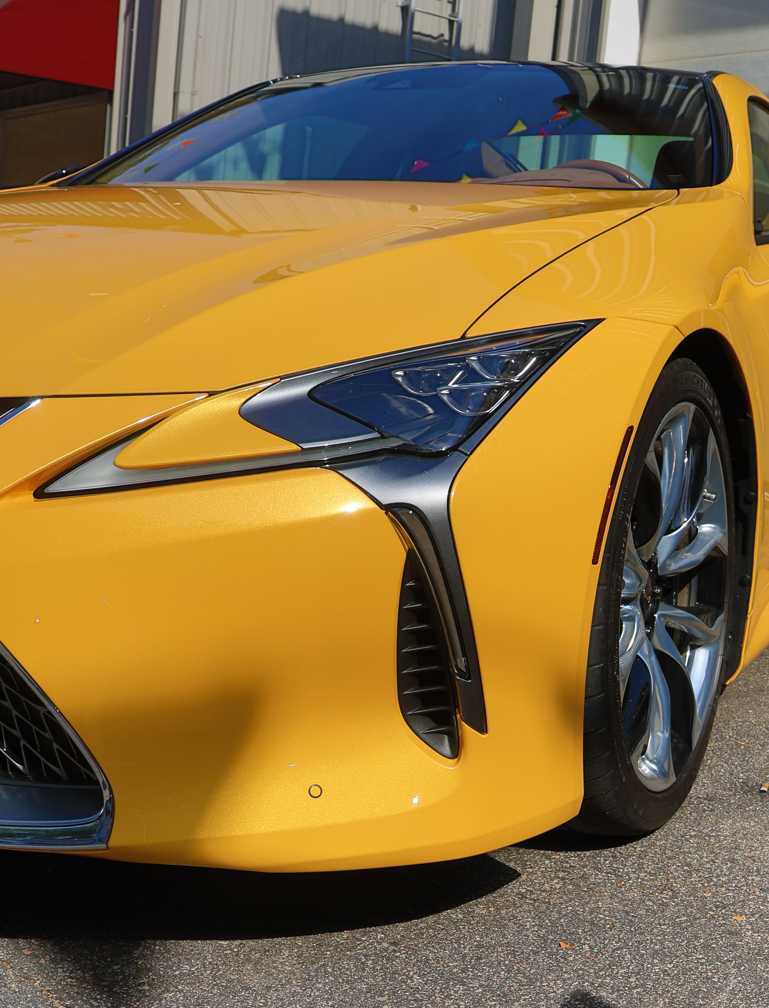 Close-up of the Lexus LC 500 front fascia featuring LED headlights and signature Lexus design elements.