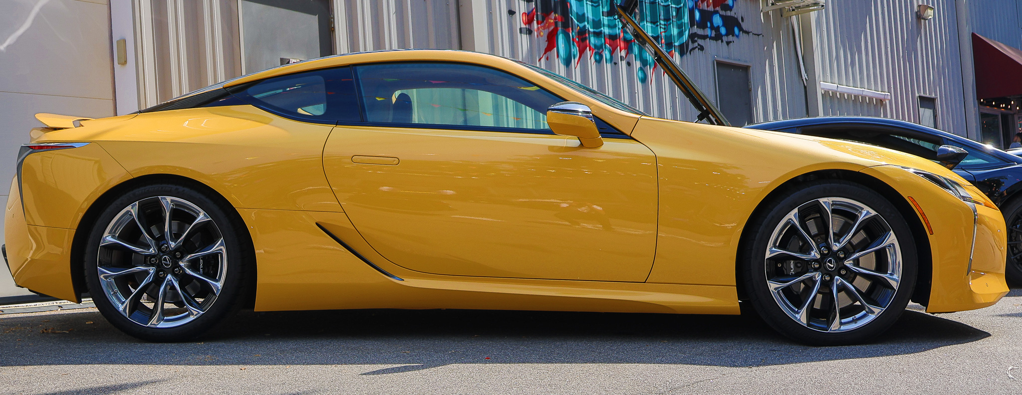 Side profile of a Lexus LC 500 highlighting the sleek roofline and luxury sports coupe proportions.
