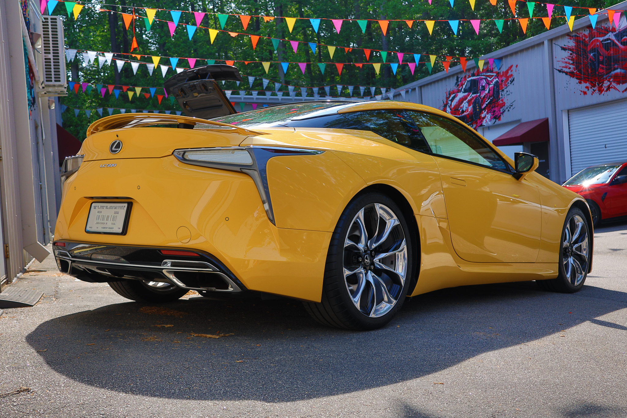 Rear three-quarter photograph of a Lexus LC 500 featuring sculpted bodywork and signature LED taillights.