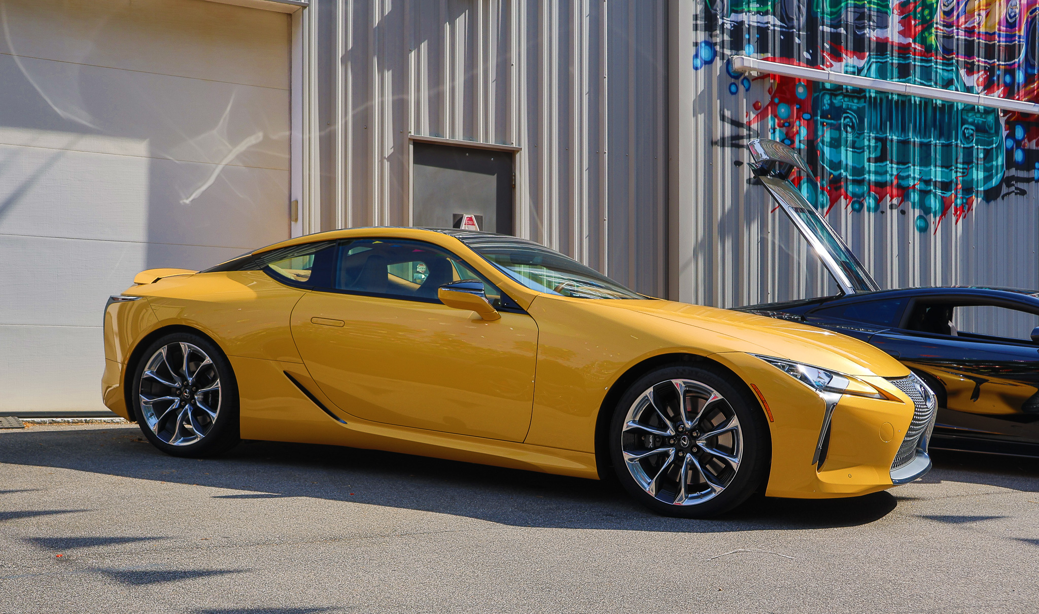 Front three-quarter view of a Lexus LC 500 showcasing its naturally aspirated V8 engine and distinctive grand touring design.